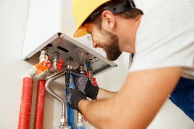 Plumber Working on a Water Heater
