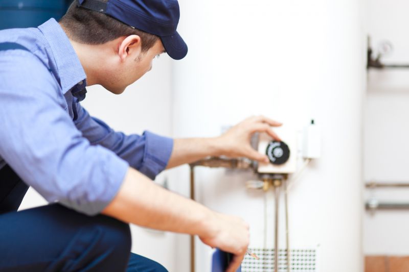 Plumber Working on a Water Heater